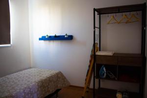a bedroom with a bed and a blue shelf on the wall at Perto do Mar, 5G, Ar e Piscina C/Churrasqueira in João Pessoa