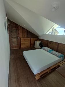 1 dormitorio con 1 cama grande en el ático en Casa Samauma Aluguel de Quartos en Florianópolis