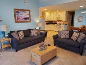 a living room with two couches and a table at Family Friendly Beach Block Ocean View 3 BR, 2 BA, Condo near Wildwood Crest and Convention Center in Wildwood