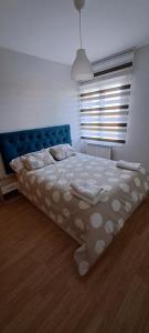 a bedroom with a large bed with a blue headboard at cuestas del arevalillo in Arévalo