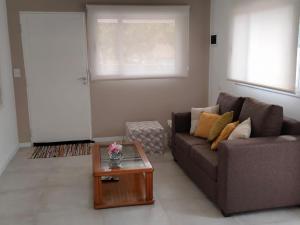 a living room with a couch and a coffee table at Los Zorzales in Villa Carlos Paz