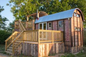 a house with a deck on a wooden fence at Get Away Hide Away in East Dereham