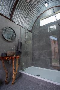 a bathroom with a shower and a sink and a tub at Get Away Hide Away in East Dereham