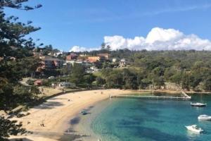 a view of a beach with boats in the water at Manly family executive apartment in Sydney