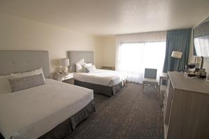 a hotel room with two beds and a window at La Serena Inn in Morro Bay