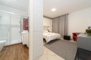 a bedroom with a bed and a bathroom at The Top Floor - Rome FCO Airport in Fiumicino