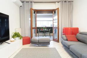 een woonkamer met een bank en een televisie bij The Top Floor - Rome FCO Airport in Fiumicino