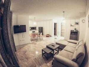 a living room with a couch and a table at ALPS Apartments in Kranjska Gora