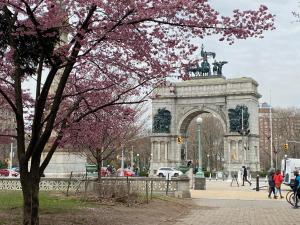 un edificio con un monumento con flores rosas. en Close to all! 2-room suite in a 1-family townhouse, en Brooklyn