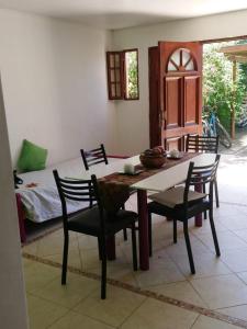 a dining room with a table and chairs and a bed at el descanso in San Antonio de Areco