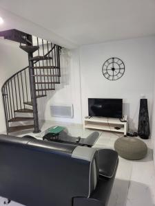 a living room with a staircase and a tv at Lou Palmieri in Marseille