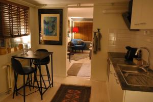 a kitchen with a table and chairs in a room at Göte`s B&B in Tumba