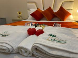 two beds with white towels and red hearts on them at Ideal For Families I Entire Comfy Appartment I Fibre Internet Up to 100 Mbps I PALMS Residence in Er Rachidia