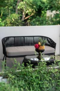 a bench with a bowl of fruit on a table at Villa Ikris - tranquil oasis in the heart of Canggu in Canggu