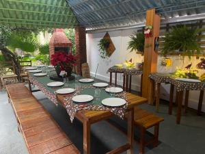 a dining room with a table with plates on it at Pousada São Jorge in Bonito +29 photos