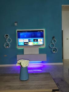 a vase with flowers in front of a tv at Chamrick's Palace in The Rock