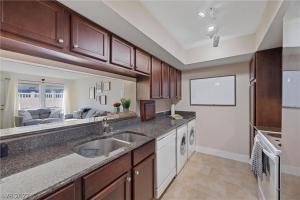 a large kitchen with a sink and a living room at LV Get-Away 1bdroom condo sleeps 3 in Las Vegas