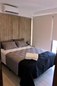 a bedroom with a large bed with a white towel on it at Mendoza Relax & Comfort in Mendoza