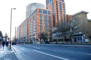 an empty city street with tall buildings at Edgware Hub in London