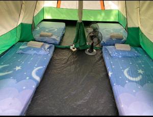 a inside of a tent with two beds in it at Outworld Basecamp in Gopeng