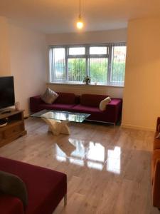 a living room with a couch and a coffee table at Lovely 3 Bedroom Entire Home With Street Parking - Close to NEC, BHX Airport - Sleeps 6 Guests IDEAL FOR CONTRACTORS & FAMILIES in Birmingham