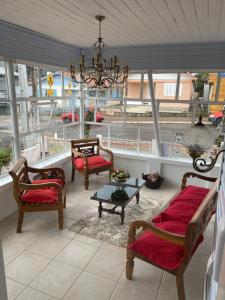 a living room with chairs and a chandelier at Pousada Expedicionário Energias da Serra in Bom Jardim da Serra
