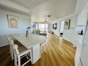 a kitchen and living room with a table and chairs at Endless Summer in Cooly Level 18 in Gold Coast