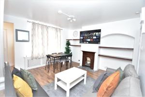 a living room with a couch and a table at Lovely 3 Bedroom House Dagenham in Dagenham