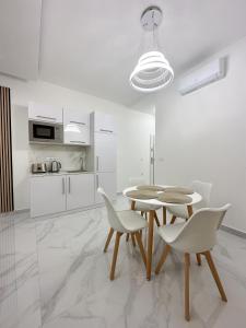 a kitchen and dining room with a table and chairs at Boutique Luxury Residence in Budapest
