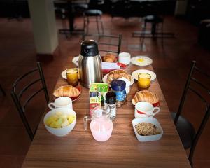 a wooden table with food and drinks on it at Mateospaxi in Machachi