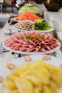 a buffet with plates of food on a table at Muong Thanh Grand Hanoi Hotel in Hanoi