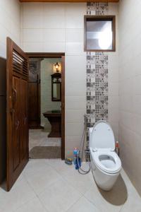 a bathroom with a toilet in a room at Nature staycation Escape From City, Belgareti Farm in Nangkabeurit
