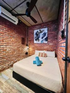a bedroom with a large bed in a brick wall at Classic Traditional Villa with Breathtaking View Pool WIFI in Pantai Cenang