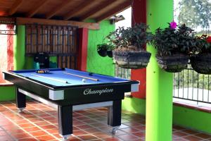 a pool table on a patio with potted plants at EL RETORNO in Marinilla