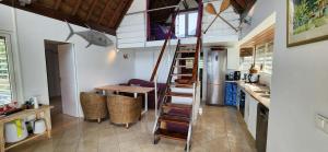 a kitchen with a spiral staircase in a house at Villa Vaihau in Papetoai