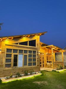 a log cabin with a porch and a patio at شاليهات ريموندا الريفيه الطائف in Taif