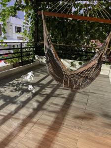 a hammock sitting on a deck in a porch at Departamento en Esmeraldas in Esmeraldas