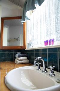 a bathroom with a sink and a mirror at Jardine Lodge - Can sleep 22! in Corryong