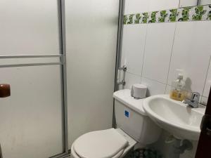 a bathroom with a toilet and a sink at Apartamento cerca a la candelaria y hospitales principales de Bogota in Bogotá