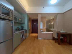 a kitchen and dining room with a table and a sink at Tianjin Crown International Apartment in Tianjin