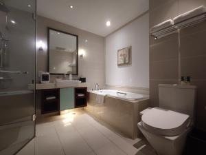 a bathroom with a toilet and a sink and a shower at Tianjin Crown International Apartment in Tianjin