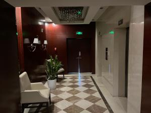 a lobby with a waiting room with chairs and a door at Tianjin Crown International Apartment in Tianjin