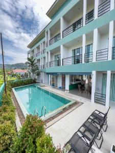 an apartment with a swimming pool and a building at Melissa Kata Beach Resort in Kata Beach