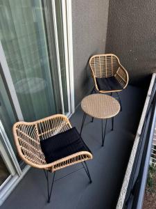 two wicker chairs and a table on a balcony at Tulum Vibes 1 Bedroom Apartment near Boats in Marina Del Rey in Los Angeles