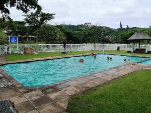 a group of people in a swimming pool at Eden Wilds Unit 125 in Port Edward