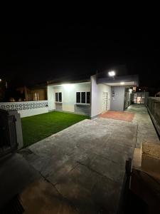 a night view of a house with a yard at Roomah Istana in Ipoh