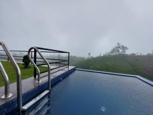 a pool of blue water with two metal railings in at Harrington Heritage in Hatton +86 photos