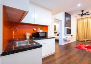 a kitchen with a sink and a microwave at Greystone Centrestage PJ in Petaling Jaya