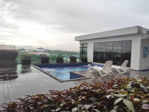a patio with two chairs and a plant at 2Bedroom 5 Mins to MidValley 10 Mins to CIQ in Johor Bahru