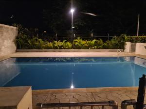een zwembad in een tuin 's nachts bij Moderno amplio y acogedor apartamento en el sur de cali in Cali